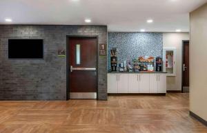 a lobby with a door and a tv in a room at Extended Stay America Suites - Fort Lauderdale - Plantation in Plantation