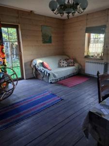 A bed or beds in a room at Agroturystyka LipoweWzgórze domek Danusia