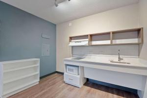 an empty kitchen with a sink and a counter at Extended Stay America Suites - Miami - Airport - Blue Lagoon in Miami