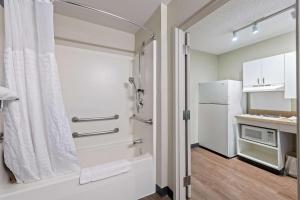 a bathroom with a shower and a refrigerator at Extended Stay America Suites - Miami - Airport - Doral in Miami