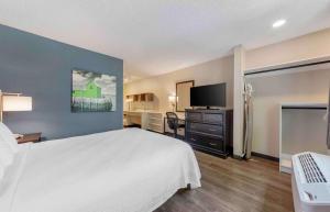 a hotel room with a bed and a flat screen tv at Extended Stay America Premier Suites - Miami - Airport - Doral - 87th Avenue South in Miami