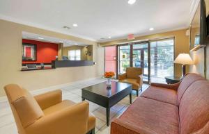 a living room with a couch and chairs and a table at Extended Stay America Suites - West Palm Beach - Northpoint Corporate Park in West Palm Beach