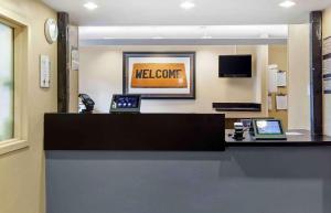 a lobby with two laptops on a reception counter at Extended Stay America Suites - Boston - Waltham - 32 4th Ave in Waltham