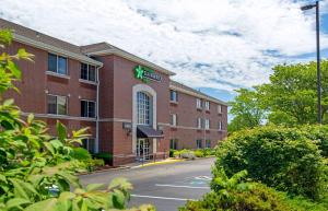 a building with a sign on the side of a street at Extended Stay America Suites - Boston - Woburn in Woburn