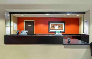 a cash counter with two cell phones on it at Extended Stay America Suites - Meadowlands - Rutherford in Rutherford