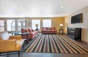 a living room with couches and a flat screen tv at Extended Stay America Suites - Secaucus - New York City Area in Secaucus