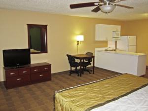 a hotel room with a bed and a table and a kitchen at Extended Stay America Suites - Somerset - Franklin in Somerset