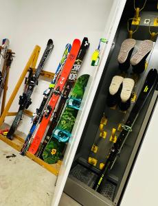 a row of skis and snowboards in a drawer at DOLOMITI HOUSE 9 in Fiera di Primiero