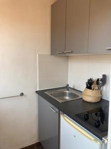a kitchen with a sink and a counter top at La Maison sur les Toits in Aix-en-Provence
