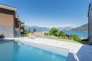 a swimming pool with a view of the water at ANNA'S LODGE QUITE & CHARME in Pianello Del Lario