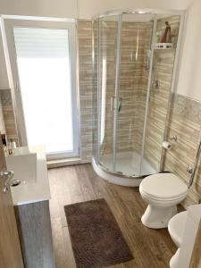 a bathroom with a shower and a toilet at Coastal Apartment Ribera 45 sqm Sea View in Ribera