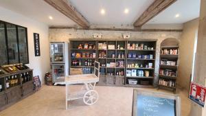 a room with a store with a lot of products at Le Domaine du Bois Coquet in La Douze