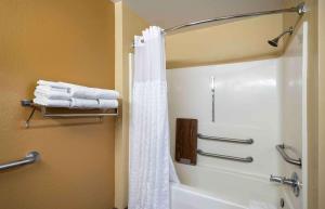y baño con ducha y cortina de ducha blanca. en Extended Stay America Suites - Frederick - Westview Dr, en Frederick