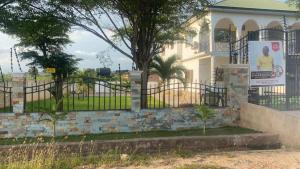 a house with a gate in front of it at Charming 1-Bed Apartment in Accra in New Weija