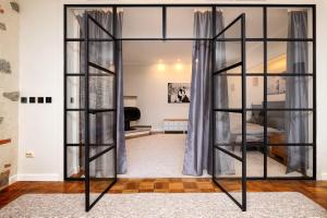 a glass bookcase in a room with a bedroom at Toompea Castle Apartment in Tallinn