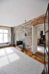 a living room with a brick wall and a fireplace at Toompea Castle Apartment in Tallinn