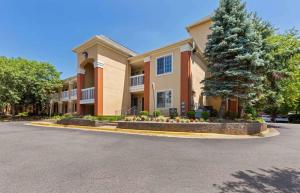 a large building with a tree in front of it at Extended Stay America Suites - Washington, DC - Chantilly in Chantilly