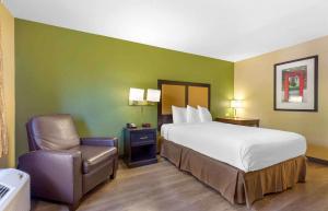 a hotel room with a bed and a chair at Extended Stay America Suites - Washington, DC - Chantilly - Dulles South in Chantilly