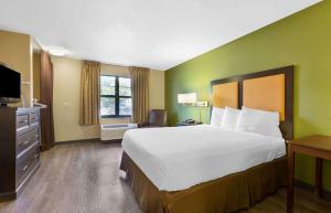 a hotel room with a large bed and a television at Extended Stay America Suites - Washington, DC - Chantilly - Dulles South in Chantilly