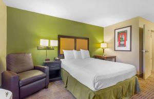a hotel room with a bed and a chair at Extended Stay America Suites - Washington, DC - Chantilly - Dulles South in Chantilly