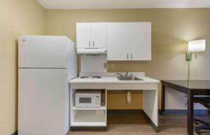 a kitchen with a sink and a white refrigerator at Extended Stay America Suites - Washington, DC - Chantilly - Dulles South in Chantilly