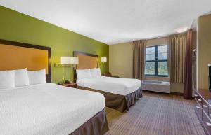 a hotel room with two beds and a window at Extended Stay America Suites - Washington, DC - Chantilly - Dulles South in Chantilly