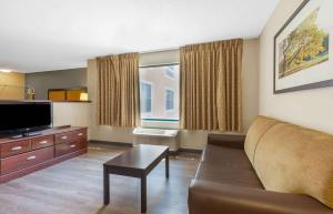 a living room with a couch and a flat screen tv at Extended Stay America Suites - Washington, DC - Chantilly - Dulles South in Chantilly