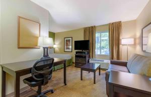 a hotel room with a desk and a bed at Extended Stay America Suites - Washington, DC - Fairfax in Fairfax