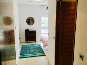 a hallway with a mirror and a rug on the floor at Eight Water's Edge in Tenby