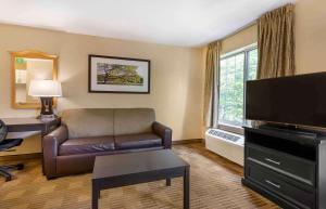 a living room with a couch and a flat screen tv at Extended Stay America Suites - Washington, DC - Alexandria - Eisenhower Ave in Alexandria