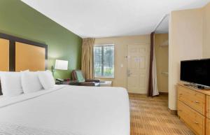 a hotel room with a bed and a flat screen tv at Extended Stay America Suites - Washington, DC - Sterling - Dulles in Sterling