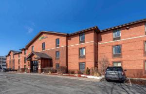 a brick building with a car parked in front of it at Extended Stay America Suites - Des Moines - West Des Moines in Clive