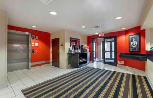an empty lobby with red walls and a door at Extended Stay America Suites - Chicago - Darien in Lemont
