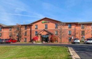 a large red brick building with a hotel at Extended Stay America Select Suites - Rockford - State Street in Rockford