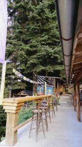 a group of tables and chairs in front of a tree at Malka Yurta Hut in Panichishte