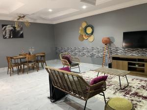 un soggiorno con sedie, TV e tavolo di Tamaniroom- a private 1bed a Tamale