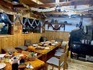 a dining room with a table with food on it at Malka Yurta Hut in Panichishte