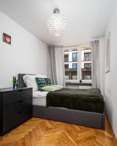 a bedroom with a bed and a window at Apart D&K Blisko Stadionu Narodowego in Warsaw