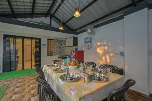 a dining room with a table and some chairs at Great Escape Villa by Tropicana Stays in Lonavala