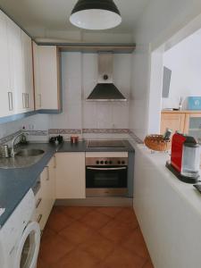 a small kitchen with a stove and a sink at Pita 1 in Níjar