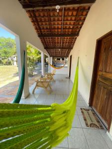 a hammock on the porch of a house at Chalés São Domingos in Barreirinhas