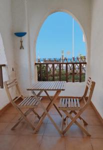 a picnic table and two chairs on a balcony at Pita 1 in Níjar +4 photos