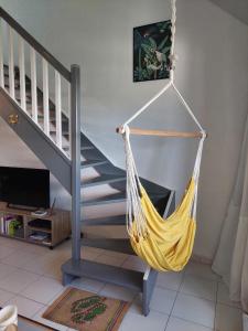 a hammock hanging from a staircase in a living room at Pelican in Saint Martin