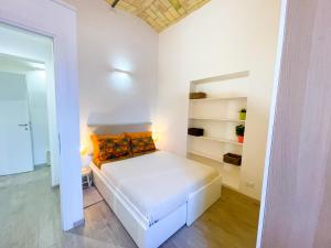 a white bedroom with a white bed and shelves at Casa Pesa 2 rooms 2 baths Rome center in Rome