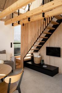 eine Treppe im Wohnzimmer mit Sofa und TV in der Unterkunft NALAS domki z widokiem in Rabka-Zdrój