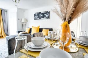 uma sala de jantar com uma mesa com pratos e cadeiras em LIVERPOOL HOME with FREE PARKING em West Derby