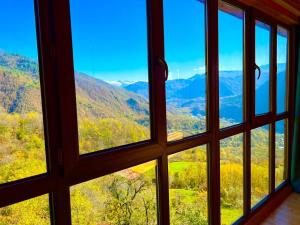 a view from a window of a mountain view at Gentry House in Ambrolauri