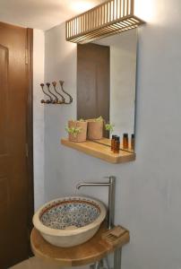 a bathroom with a large sink and a mirror at Aqua Bliss in Xerokampos