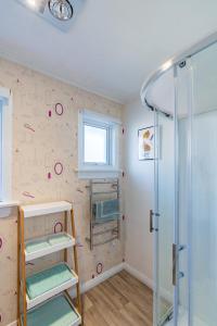 a bathroom with a shower with a glass door at Modern home in Dunedin in Dunedin