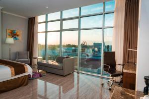 a hotel room with a bed and a large window at Hotel City Plaza & Suites in David